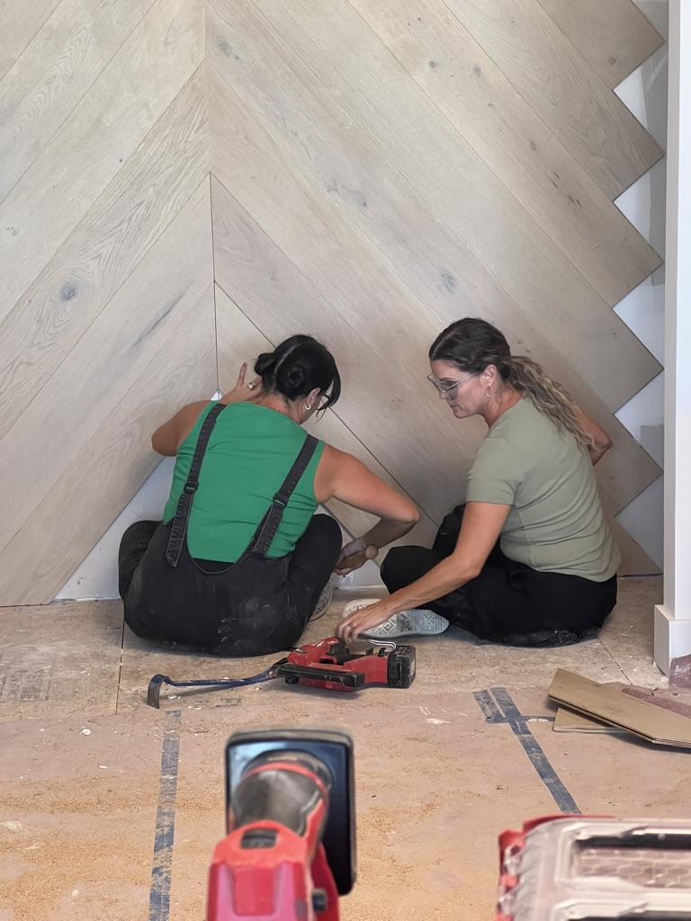 Lamb&Co team installing Laguna floor planks in chevron pattern 