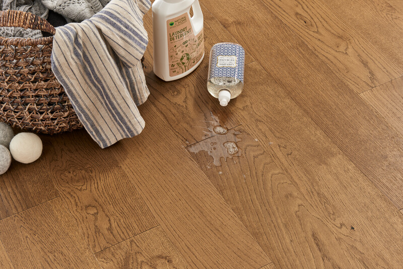 Spilled detergent bottle showing the waterproof performance of HydroGuard engineered hardwood for kitchens