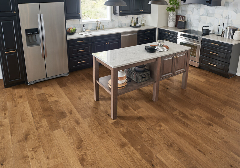 Kitchen area with an island using engineered wood flooring