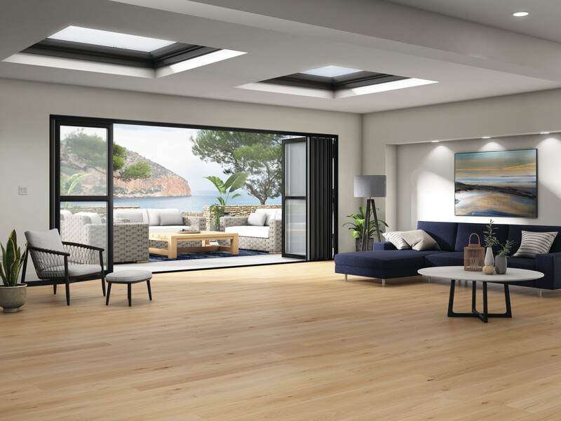 Open concept living room with a floating floor and large patio doors overlooking the ocean