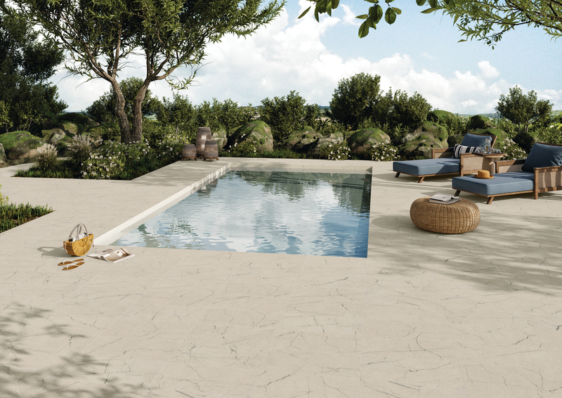 Swimming pool with a decking area using porcelain stone tile