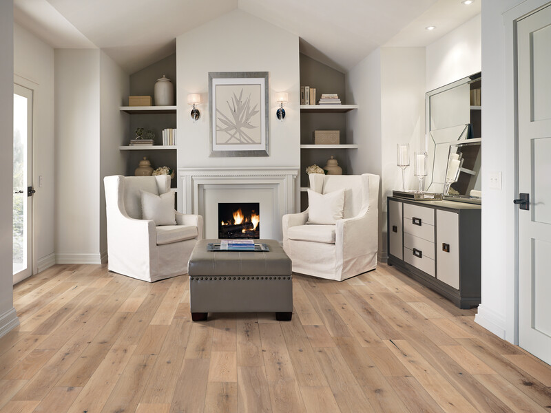 Seating area with bookshelves and fireplace and white oak flooring