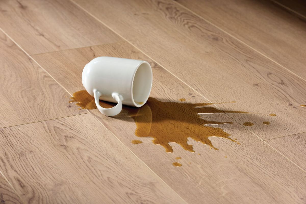 Spilled coffee cup on a laminate floor presenting its waterproofing